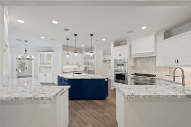Kitchen featuring high end appliances, a kitchen i