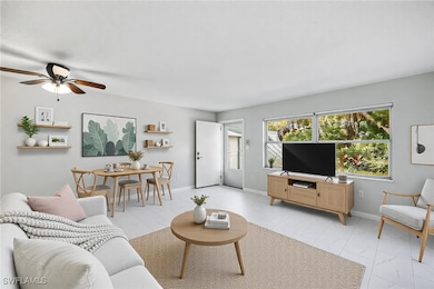 Living room with baseboards, tile floor, and ceili