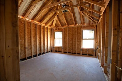 Miscellaneous room featuring vaulted ceiling and a