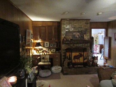 Living area featuring a brick fireplace and wooden