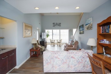 Living area featuring dark wood finished floors and recessed lighting