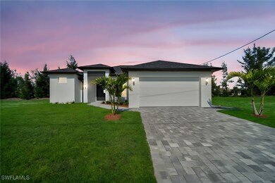 View of front of house featuring decorative drivew
