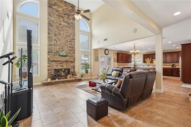 Living area featuring baseboards, a stone fireplac