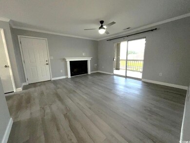 Unfurnished living room with ornamental molding, c