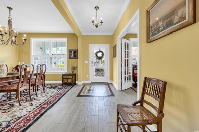 Foyer entrance featuring a chandelier and wood finished floors