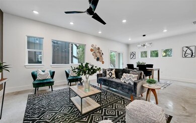Living area with visible vents, baseboards, a cei