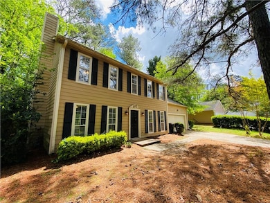Colonial house featuring an attached garage, drive