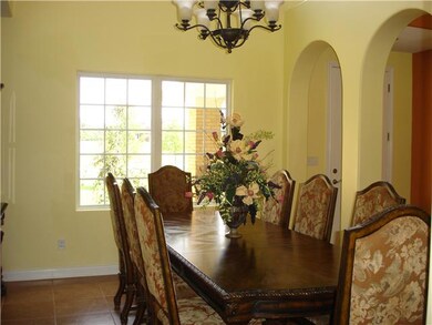 Formal dining room with arched entry from foyer.