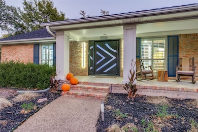 Featuring a stunning custom iron front door and a distinctive metal roof crafted to resemble classic shingles