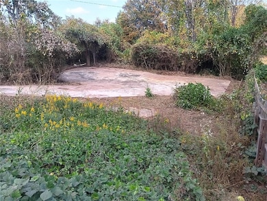 View of yard featuring a driveway and parking area