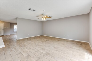 Unfurnished room with ceiling fan and baseboards