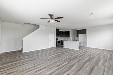 Unfurnished living room with ceiling fan, sink, and wood-type flooring