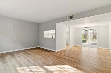 Spare room featuring baseboards, visible vents, li