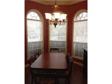 Formal Dining Room with Bay Window and Wood Floors