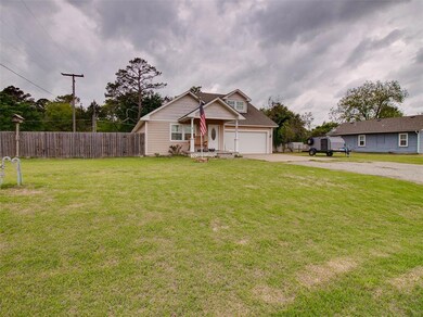 View of front facade with a garage and a front law
