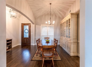 Formal dining area with light pouring in thru the front windows.
