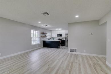 Unfurnished living room featuring light wood-type