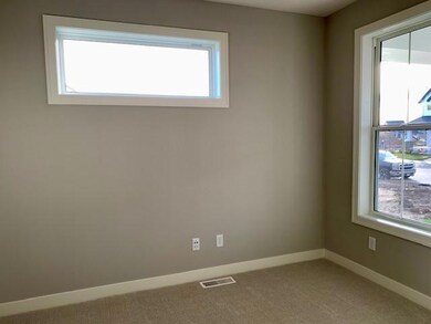 Main floor flex room includes multiple window - perfect space to work from home!