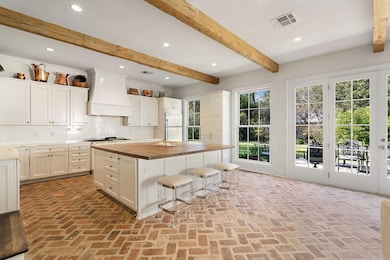 Spacious chef's kitchen with plenty of storage, counter space, and an eat in island.