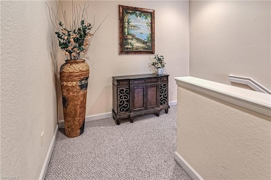 Hallway with light carpet