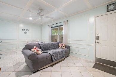 Living room featuring a decorative wall, a ceilin