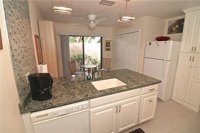 QUARTZ COUNTERTOPS AND CUSTOM GLASS TILE WALL