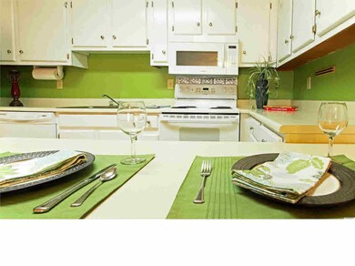 Just a perfect kitchen. Bright white cabinets, all appliances stay, and eat-in bar for meals. It is open to the living room