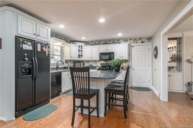 Bright kitchen has island with breakfast bar