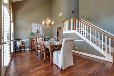Notice the two story ceilings in the foyer and dining area, as well as the alcove, between the formal dining room and kitchen, perfect for a bar or butler's pantry...