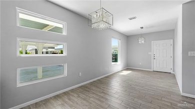 Unfurnished dining area featuring a chandelier and light wood-style floors