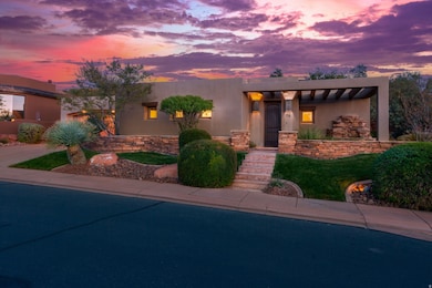 View of front of house featuring stucco siding and a patio area