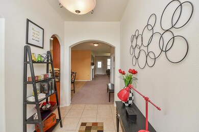 As you enter the home, step in through a wood and glass front door. The entryway has a high ceiling and tile floor. You ll LOVE the natural light throughout.