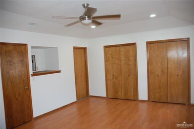 Unfurnished bedroom with multiple closets, wood finished floors, recessed lighting, and a ceiling fan
