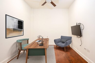 Office area with ceiling fan and dark wood-type fl