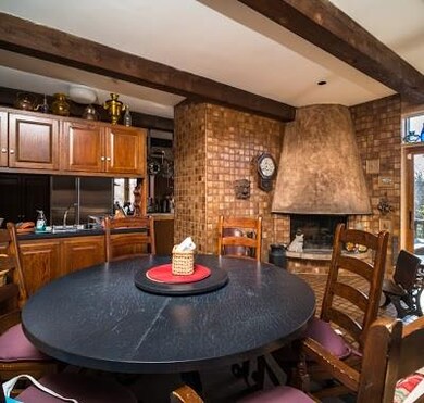 The kitchen eating area has a wood burning firepla