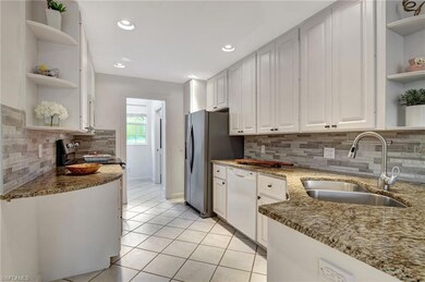 Kitchen featuring white cabinetry, sink, tasteful 