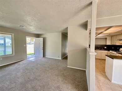 Unfurnished living room featuring sink, light tile