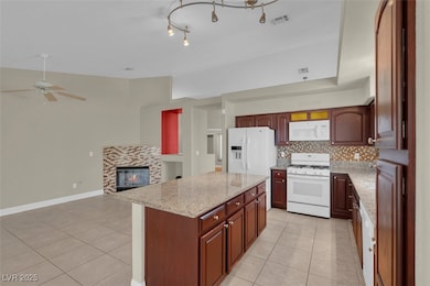 Kitchen with white appliances, light tile patterne