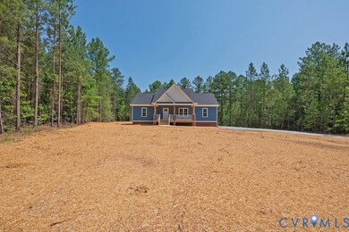 View of front of home featuring a wooded view