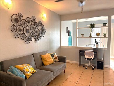 Office area with a wealth of natural light, tile patterned flooring, baseboards, and a textured wall