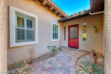 View of exterior entry featuring stucco siding and a tiled roof