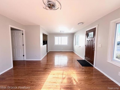 Foyer with wood finished floors and baseboards
