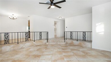 Spare room with a chandelier and a ceiling fan