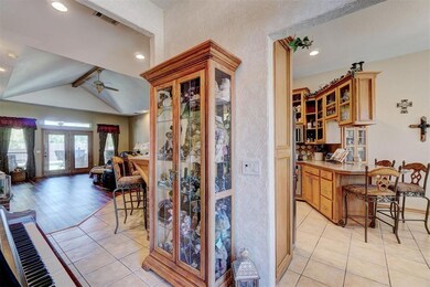 Kitchen with ceiling fan, vaulted ceiling with bea