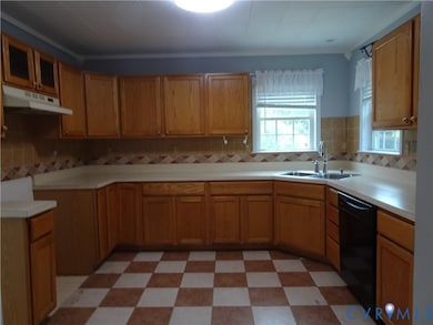 Kitchen featuring light flooring, backsplash, under cabinet range hood, dishwasher, and brown cabinets