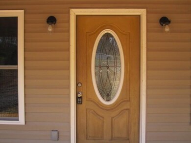 Entrance has pretty leaded glass door.