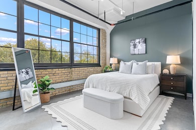 Stunning primary bedroom with big windows, bright lighting and stunning views.