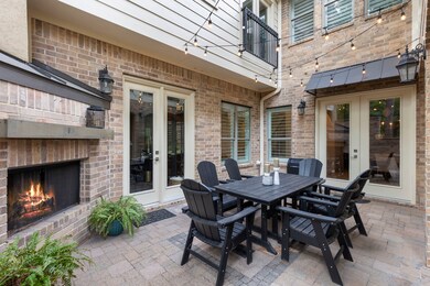The interior courtyard features a wood-burning fireplace, creating a comfortable gathering spot for every season.