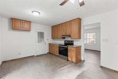 Kitchen with ceiling fan, tasteful backsplash, a t