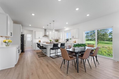(Photo of a similar home, actual homes finished will vary) Soaked in natural sunlight, the home's eat-in dining room has ample space for a dining table located in the heart of the home.